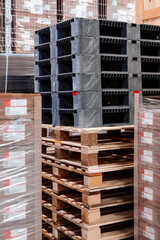 Wooden boxes and wooden pallets in the warehouse. Boxes out of wood for packing industrial machinery. Warehousing. Packaging of finished products of the plant. Sale of packaging materials.