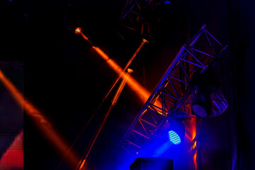 Stage lights. Background in show. Light spotlight in the dark. The interior of the theater scene is illuminated to the projector. Stage lights and stage smoke during the concert