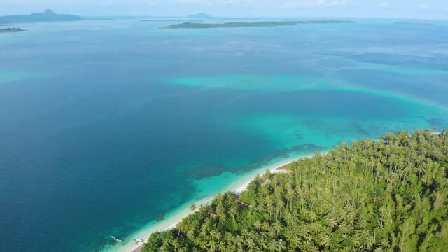 Aerial: flying over exotic white sand beach tropical island secluded destination away from it all, coral reef caribbean sea turquoise water. Indonesia Sumatra Banyak islands