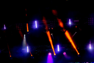 Stage lights. Background in show. Light spotlight in the dark. The interior of the theater scene is illuminated to the projector. Stage lights and stage smoke during the concert