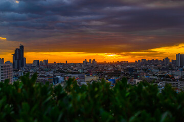 Fototapeta premium The high angle background of the city view with the secret light of the evening, blurring of night lights, showing the distribution of condominiums, dense homes in the capital community