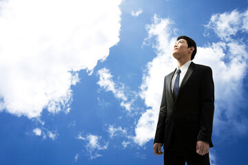 businessman standing with blue sky