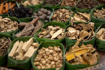 Asian dried herbs for alternative medicine therapy. Dried medicinal herbs in banana leaf tray for sacrificial offering of god in asian or thai traditional worship. 