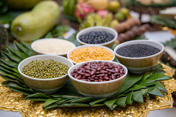 Whole grain, nut, bean, rice seed and other food in bowl for sacrificial offering in Thai traditional celebration worship.