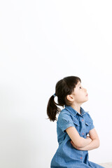 girl thinking with folded arms on white background