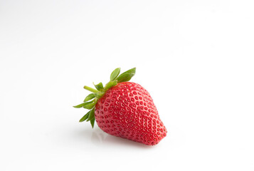 Single strawberry on white background. 