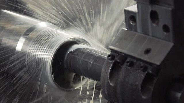 Turning lathe in action. Facing operation of metal blank on turning machine with cutting tool. Old turning lathe machine in turning workshop. Slow moton machining high precision mold part by cnc