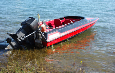 Fast small motor boat on the shore of the lake