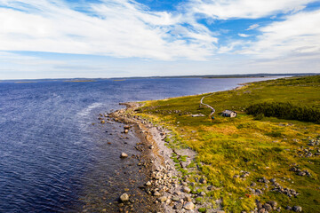 Obraz premium a panoramic view of an uninhabited island with an old church and ancient stone labyrinths filmed from a drone