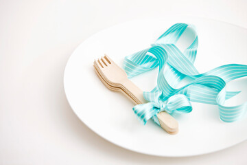 fork tied with ribbon on a plate
