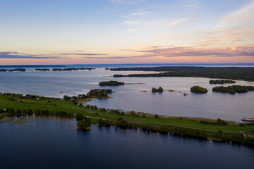 Obraz premium panoramic view of the lake with many islands on one of them there is an ancient temple made of wood at sunset filmed from a drone