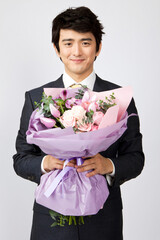 businessman holding a bouquet of flowers