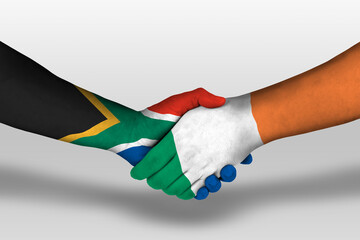 Handshake between ireland and south africa flags painted on hands, illustration with clipping path.