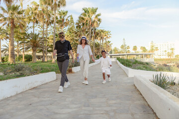 Mother and daughter walks along the seafront at the seashore  in the spring