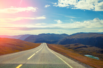 Driving a car on a mountain road. Beautiful harsh nature of Northern Norway. Polar circle. The way to Nordkapp (North Cape)