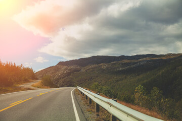 Driving a car on a mountain road. Beautiful harsh nature of Northern Norway. Polar circle. The way to Nordkapp (North Cape)