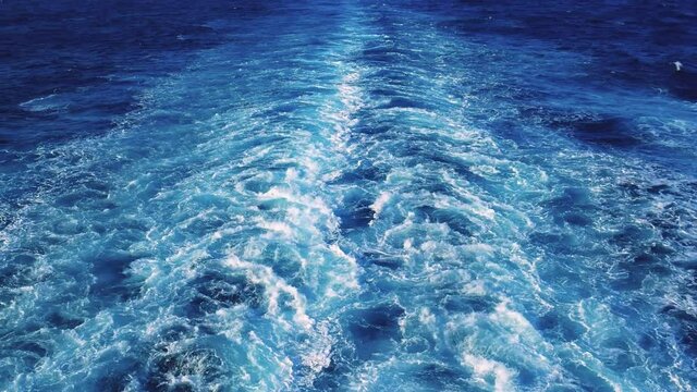 Sailing cruise ship track with calm sea and clear sky, blue sky appears in the background