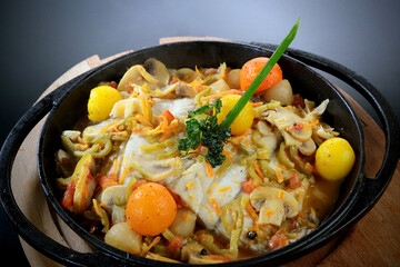 bass fish stewed in a covered pot