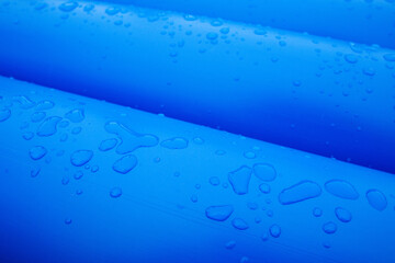 Water drops on blue plastic pipes