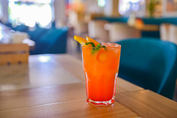 A glass with the fruit citrus cocktail. Alcohol summer beverage in a glass. Refreshing drink with ice.