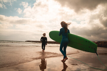 Surfer girl taking a surf lesson and going to the beach