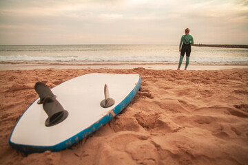 Surfer girl taking a surfboard and going to the beach