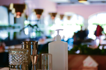 Hand sanitizer bottle on table in local restaurant for people to kill viruses. Coronavirus covid-19 pandemic.
