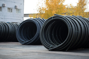Plastic pipe is stockpiled for storage in the open air
