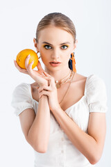 elegant blonde woman posing with orange isolated on white