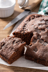 Sweet chocolate sponge cake on wooden table.	