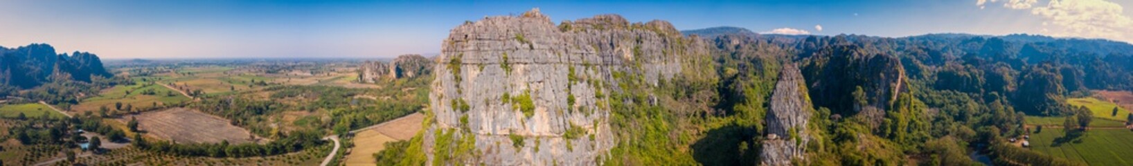 Aerial view of Limestone mountain and rice field at sunset in Noen Maprang district, Phitsanulok, Thailand.