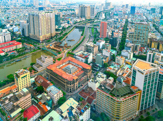 High view Saigon central skyline when afternoon down urban areas with tall buildings along  river showing development country in Ho Chi Minh City, Vietnam