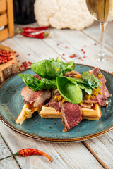 Belgian waffles with beef pastrami and greens