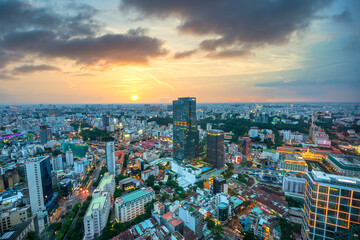 Fototapeta na wymiar High view Saigon skyline when the sun shines down urban areas with tall buildings along the road show development country in Ho Chi Minh, Vietnam