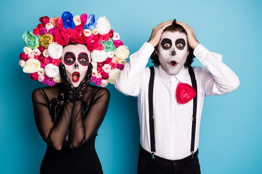 Photo of cute ghost couple man lady shocked open mouth news amazing shop proposition for dead only wear black dress death costume roses headband suspenders isolated blue color background