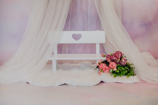 Mini Baby Bench With Pink Flowers In A Photo Studio