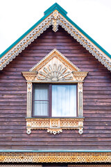  Gable wood roof isolated on white. Window framed gingerbread trims.