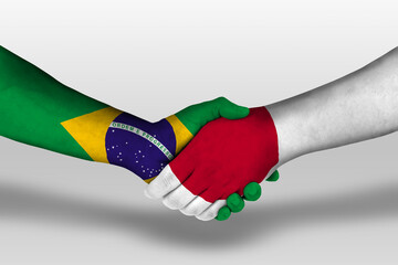 Handshake between japan and brazil flags painted on hands, illustration with clipping path.