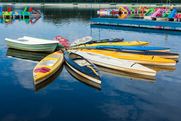 A picture of canoe and water boats on a lake.