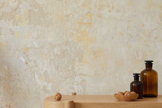 Wabi Sabi Interior Of Living Room With Wooden Console, Brown Bottles, Nuts And Copy Space. Minimalistic Concept. Template.