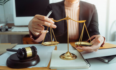 Justice and law concept.Male judge in a courtroom with the gavel, working with, computer and docking keyboard, eyeglasses, on table in morning light