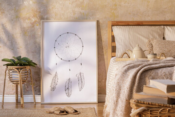 Stylish bedroom interior with mock up poster frame, design furniture, plant, rattan decoration and elegant personal accessories. Beautiful beige bed sheets, blanket and pillows. Template.