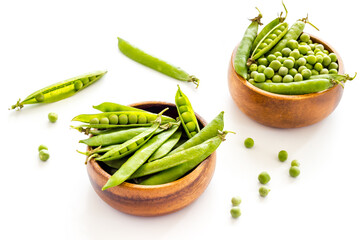 Bowl of green pea pod with beans on kitchen desk. Close up