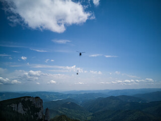 Fototapeta na wymiar helicopter over mountains