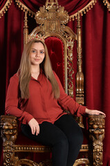 Portrait of queen with crown on chair