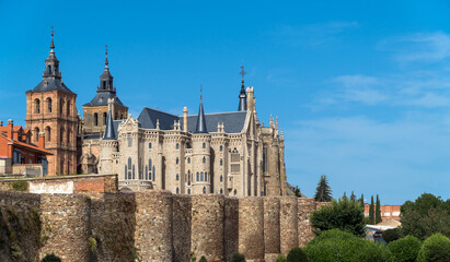 Fototapeta na wymiar Astorga, Castilla y Leon / Spain - August 11, 2020: The Roman wall, the Episcopal Palace and the Cathedral of Astorga