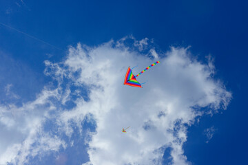 A colorful kite flying in a blue sky