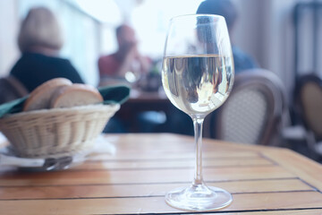 glass of white wine in the restaurant / white wine in the interior of the restaurant a table with glasses of wine, a romantic summer