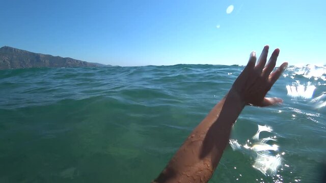 Iztuzu Beach, Dalyan, Turkey - 17th of August 2020: 4K Hand waving for help as seen by the drowing person
