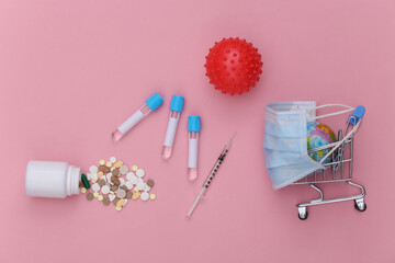 Medical supplies on a pink pastel background. Vaccination, Testing, Covid-19 Pandemic. Top view. Flat lay